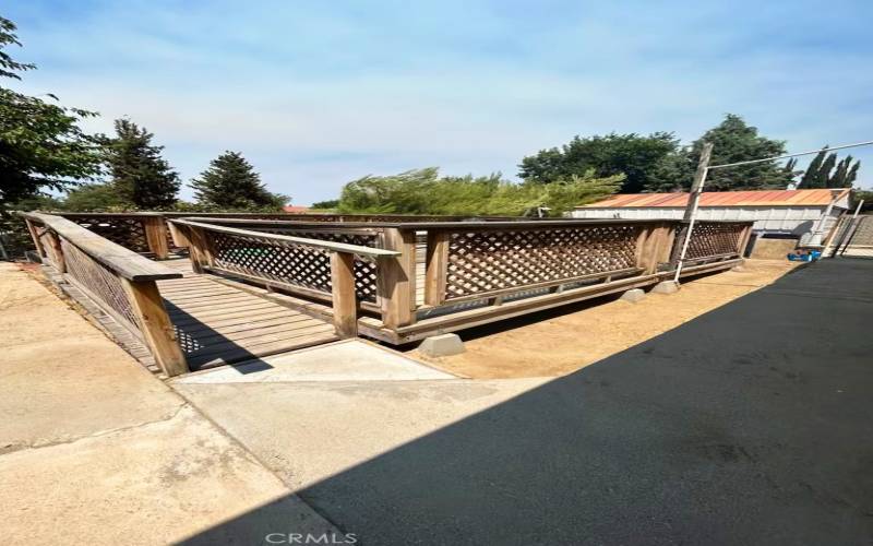 Backyard has large wood deck.