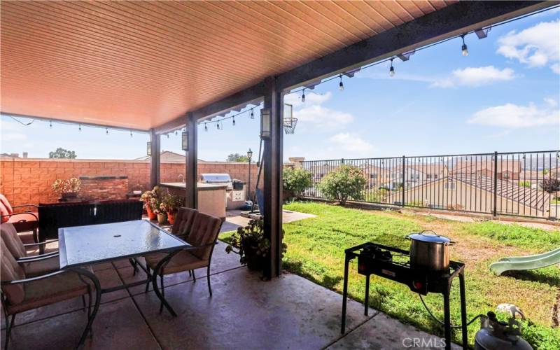 COVERED PATIO W/ OUTDOOR SEATING & BBQ AREA