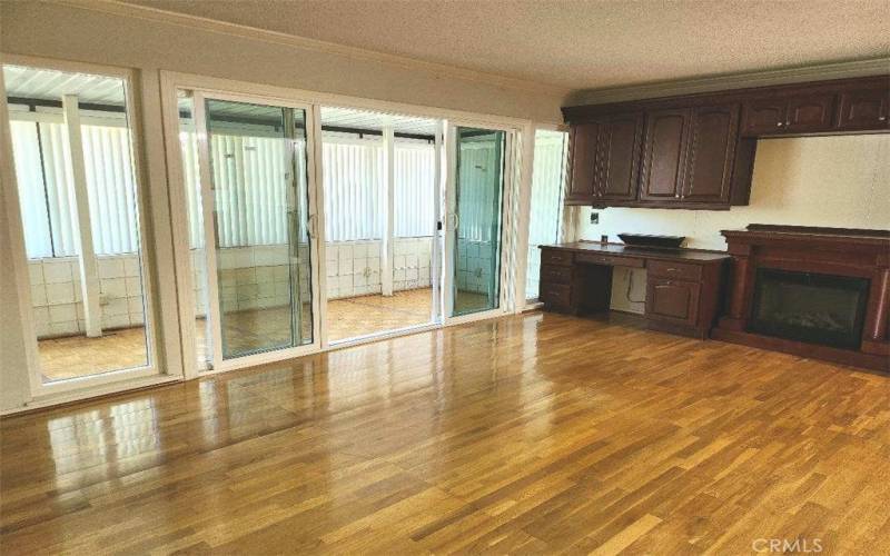 Living room & enclosed front patio view as you open entry door.