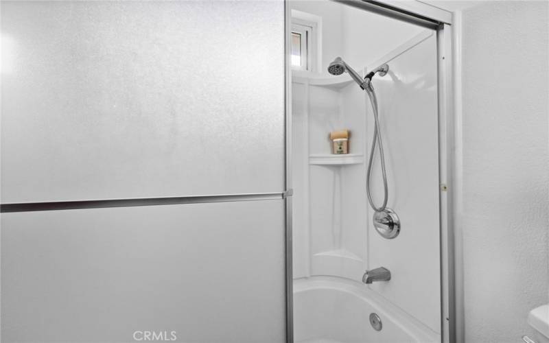 Shower and tub combo in the primary bathroom.