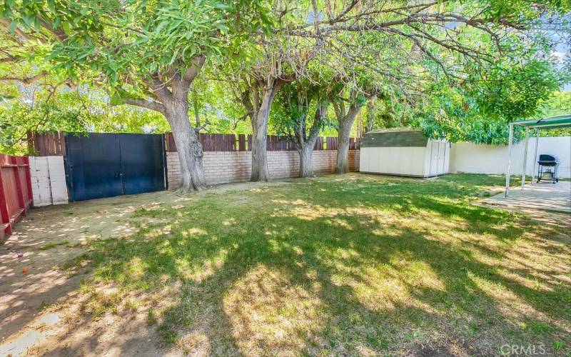 The private backyard will be a favorite entertainment destination with its covered patio and abundant towering shade trees. Plus gated RV access.