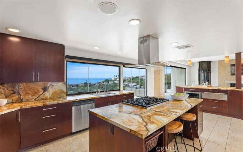 Enjoy the ocean views while working in the kitchen. 2 bar stools across from 6 gas burner stove top gives your guests a place to watch you prepare food.