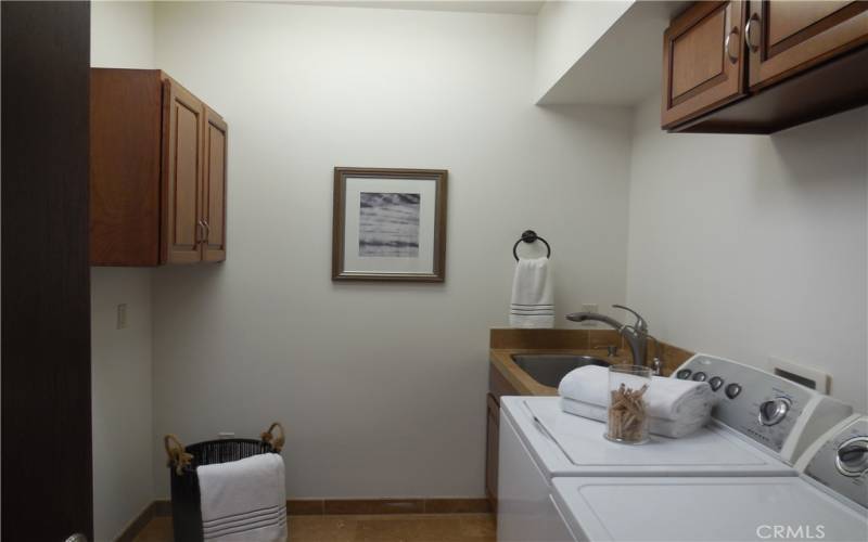 Laundry room next to master suite.  Has sky light and lots of cupboards for storage.