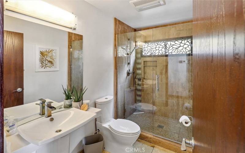 Main level bathroom with walk-in shower.