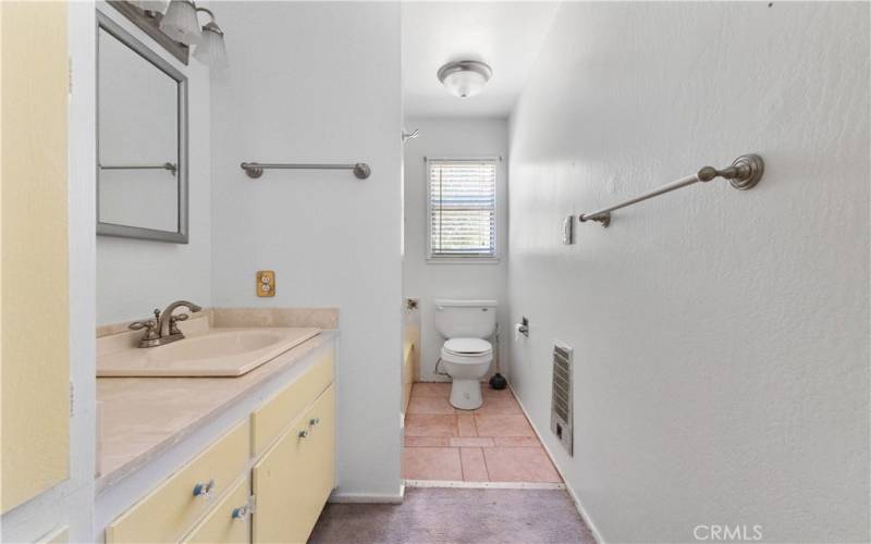 The hallway bathroom offers plenty of storage space!