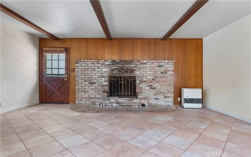 The entry features a brick fireplace.