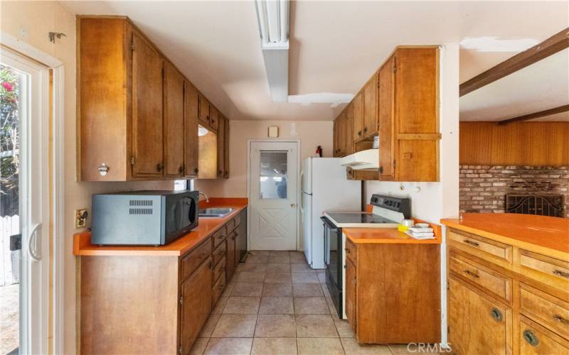 The kitchen has easy access to the dining room, a sliding door to the side yard, and a door to the garage.