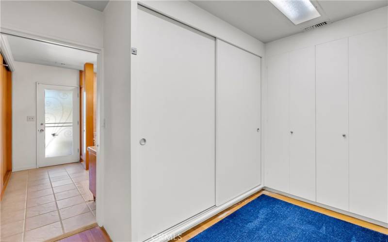 Continue down hallway on right side of house past bathroom and you reach this massive closet area on the right side. Then continue to another bathroom which has a door to the backyard for pool guests to utilize.