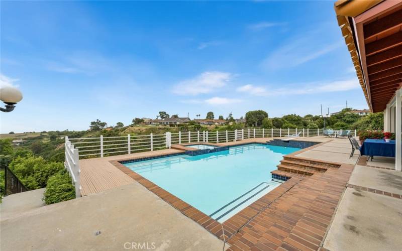 Pool and jacuzzi with deck overlooking harbor/ocean and canyon view