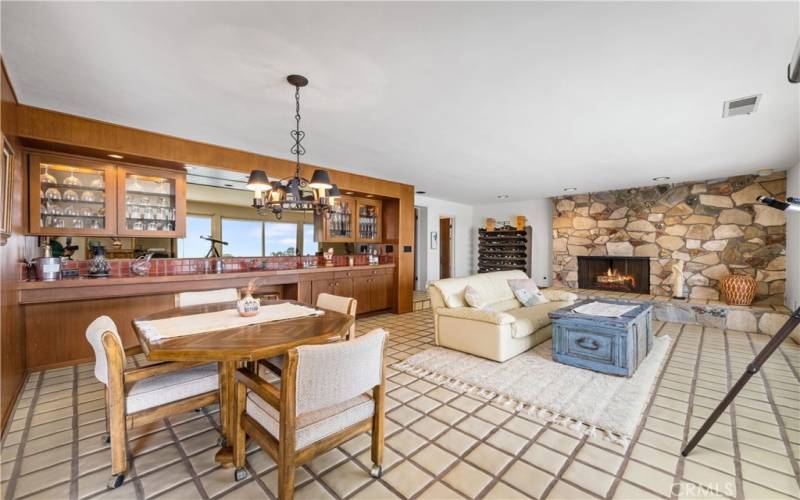 Large entertainment room with fireplace, wet bar and view