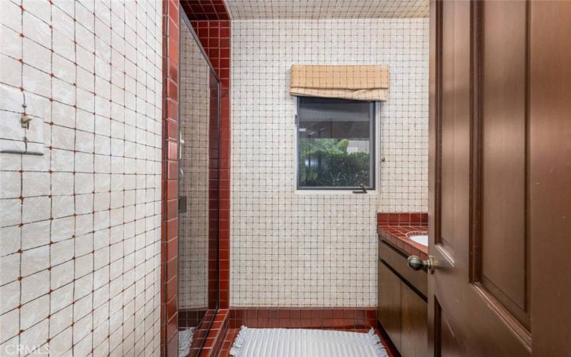 Guest Bathroom in West Wing with walk in tiled shower.