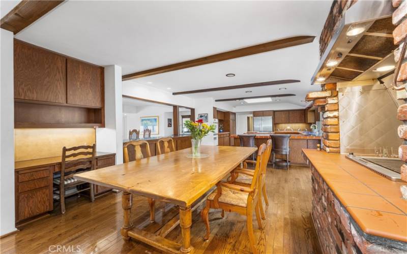 Indoor grill, seating area and desk looking towards kitchen and formal dining room