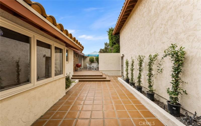 Breezeway with tiles leading to private patio