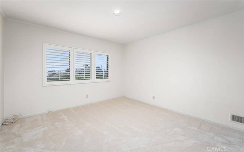 1st bedroom of West Wing. Custom shutters. New carpet. Mirrored closet doors. View room.