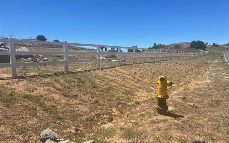 Fire  Hydrant  fronts the property  3 Rail fence on  frontage sides