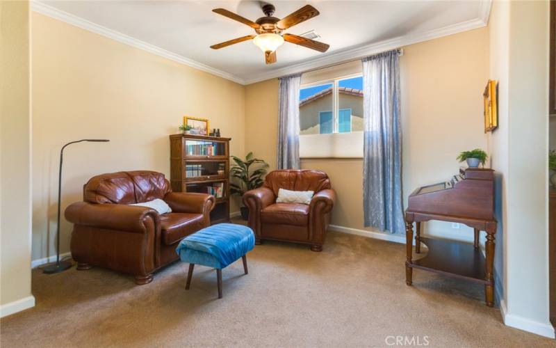 This well-lit Kitchen-adjacent room, may be utilized for several functions. Note the crown molding upgrades?