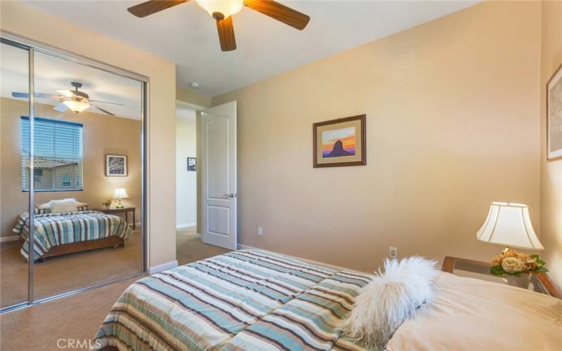 Guest Bedroom view toward hallway and bathroom. Note spacious double-door mirrored closet.