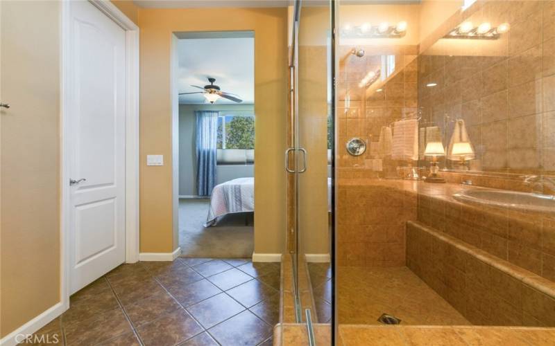 Primary Bathroom is adjacent to large bedroom and sports a luxurious shower surround with lush tile treatment.