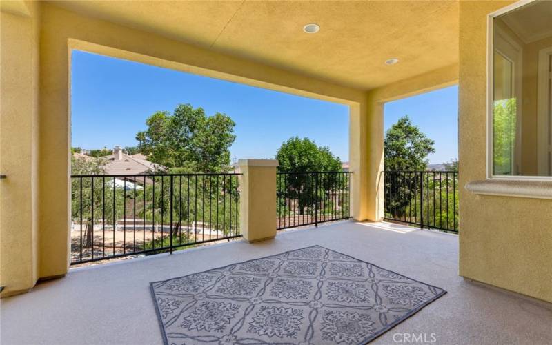 This ample, private, covered rear patio-deck is well-protected from the elements.