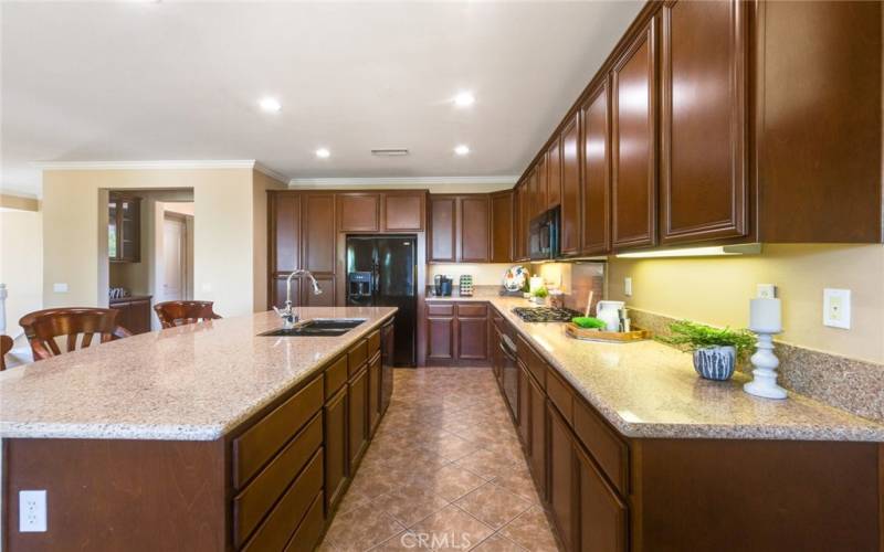 Beautiful non-porous siltestone/quartz countertops and lush dark wood cabinetry make this Kitchen sparkle