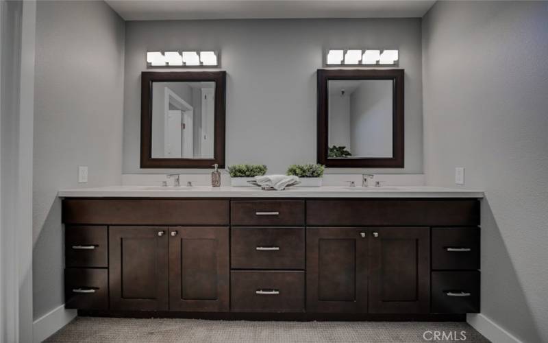 Dual Vanities with quartz countertops.