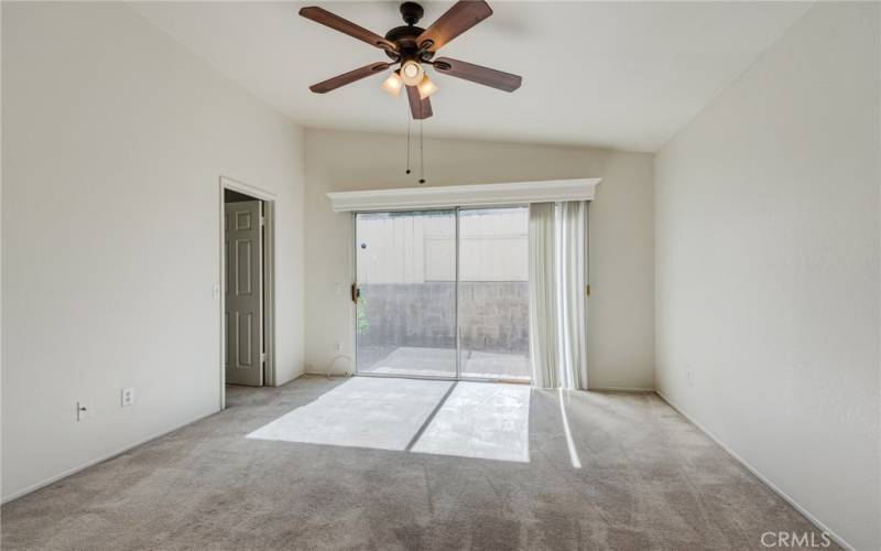 Primary bedroom with sliding glass door to back yard