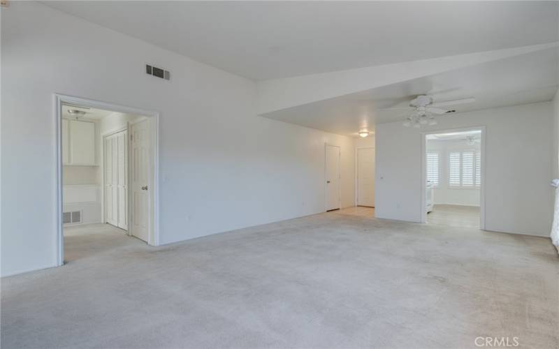 Living room looking toward front door and kitchen