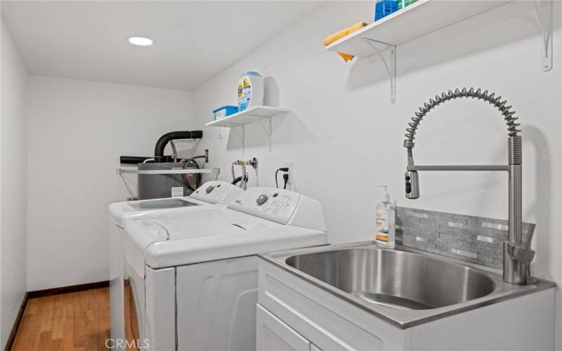 Laundry room with utility sink is located on the first floor.