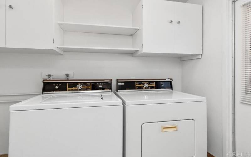 The Laundry Room has additional cabinets and shelves for overflow storage.