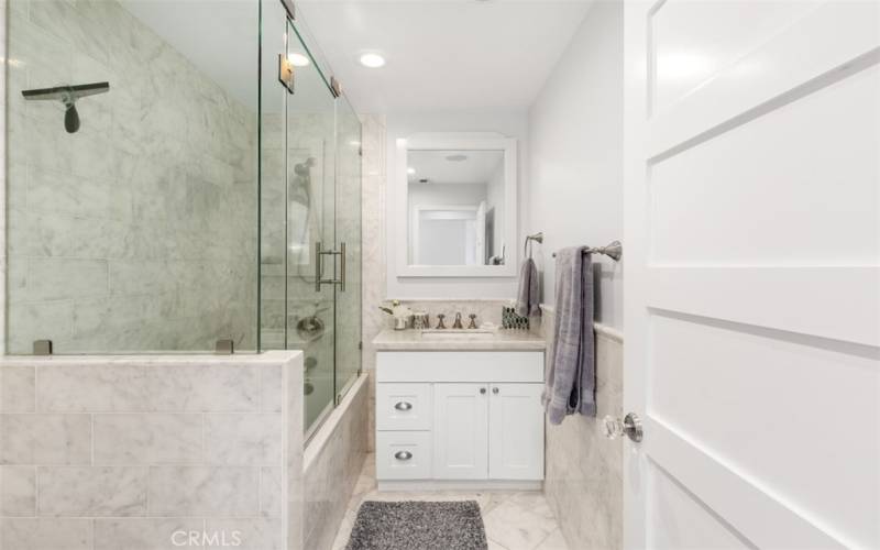 Bathroom with tub-in shower on upper level.