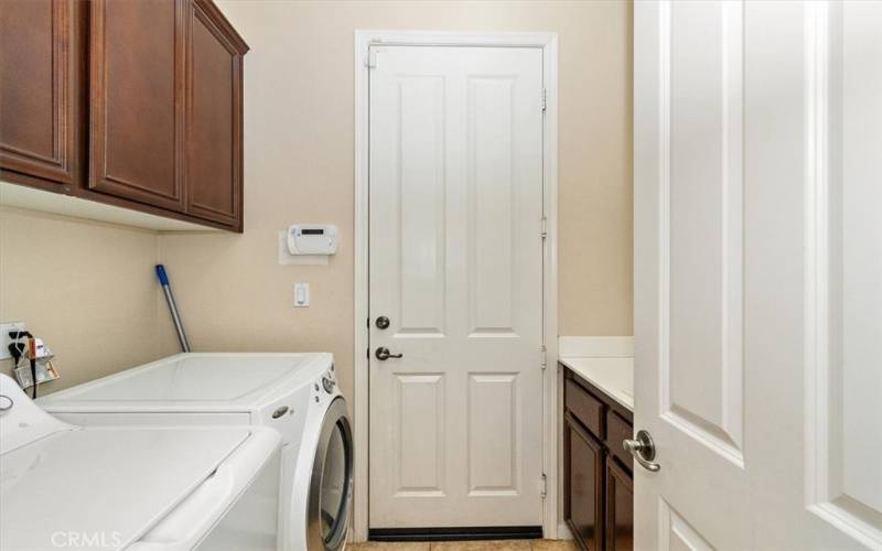 Indoor Laundry area with sink leading out to garage