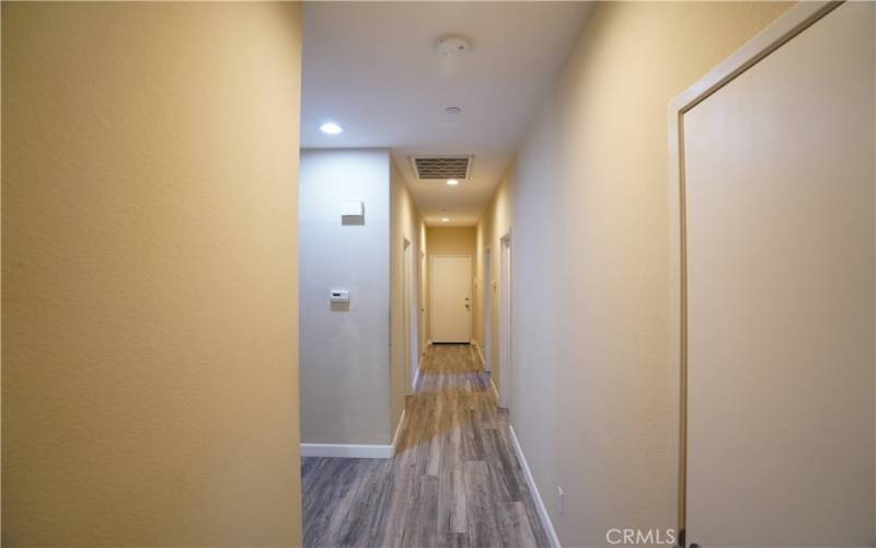 Hallway leading to other two bedrooms and second bedroom