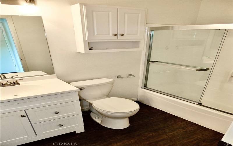 Bathroom offers shower in tub combination, vanity and medicine chest.