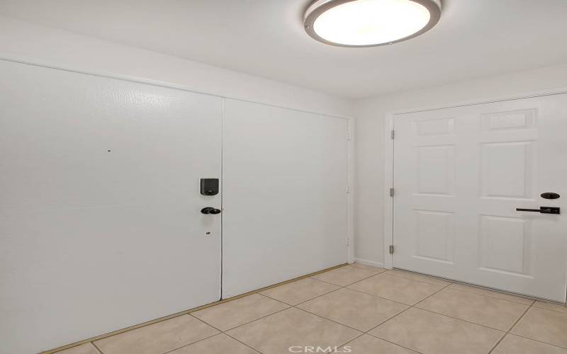 Foyer with double doors and the door to the garage.  Electronic entry!