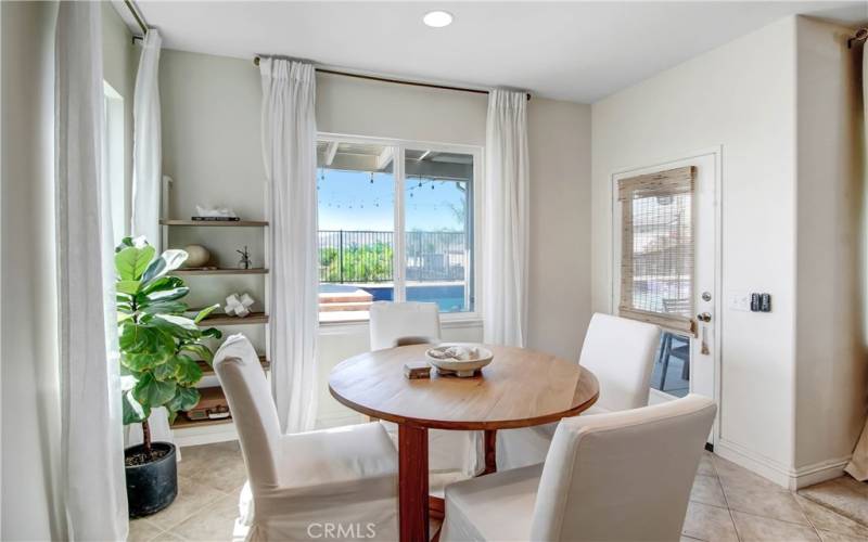 Breakfast area w/ access to backyard pool area.