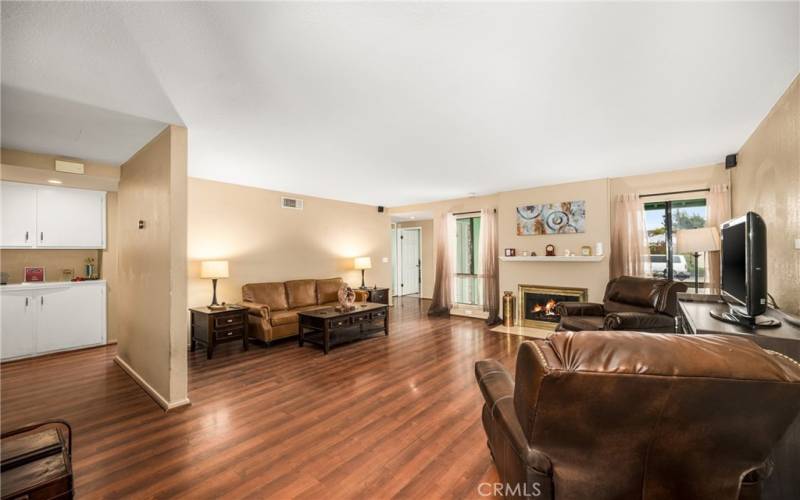 Large Living Room with wood-burning fireplace - View from Dining area. Note the light from South-facing windows!