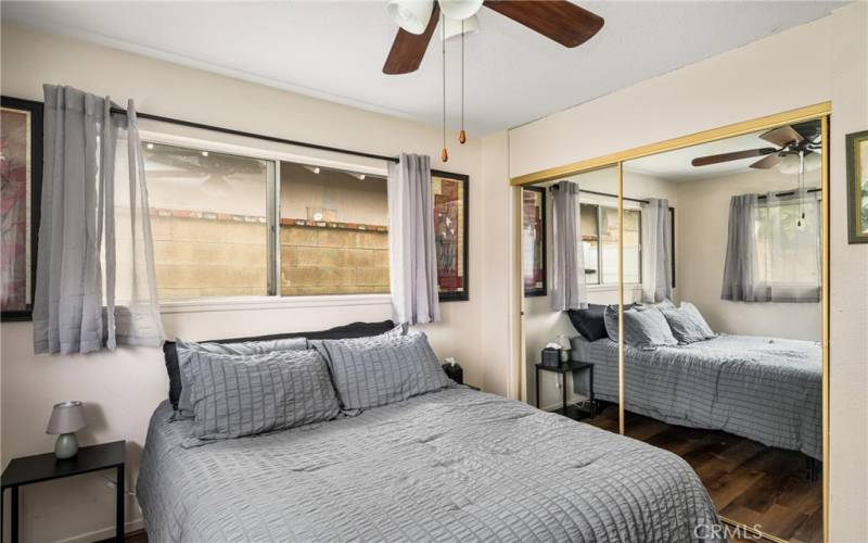 Another view of spacious Bedroom #2 with ceiling fan and mirrored closet door!