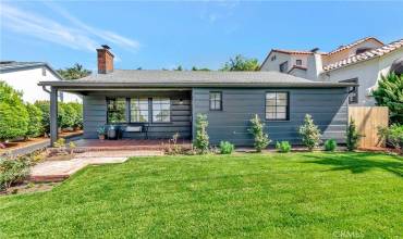 Front view of house with wide covered porch and landscaping