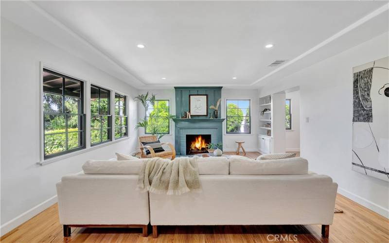 Living/Family room with decorative fireplace and raised tray ceiling