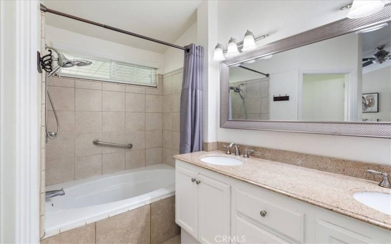 Primary bathroom with Tile in Combo shower and bathtub.