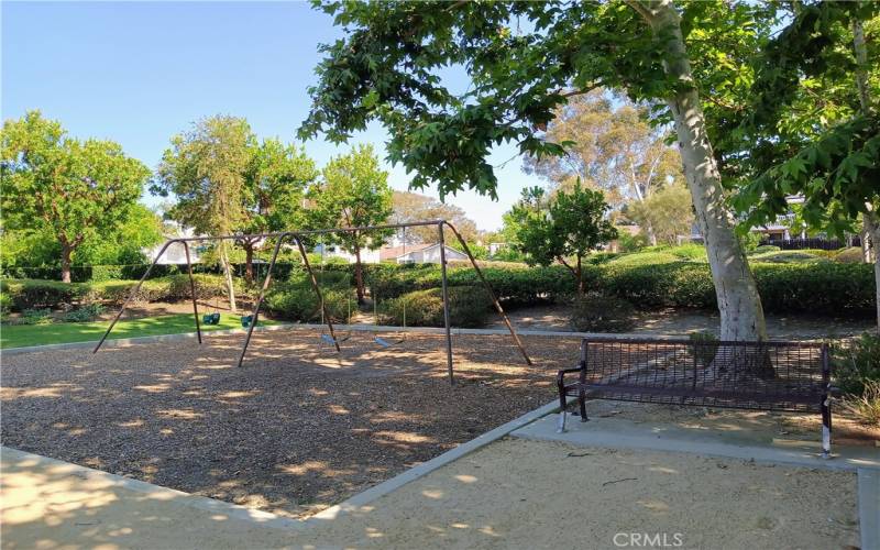 SWING SET NEXT TO PARK BENCH - 1 OF MANY BENCHES ALONG TIMBERLINE HOA  TRAILS