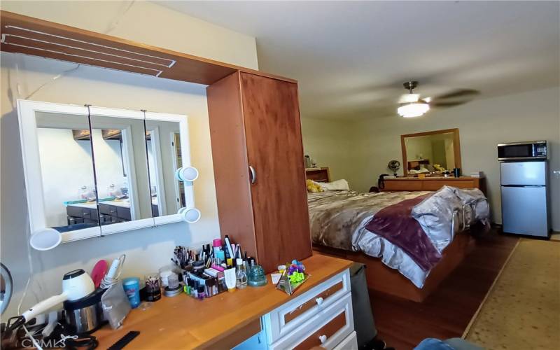 Primary Bedroom vanity & desk area behind - beside large window looking out onto back of house trail