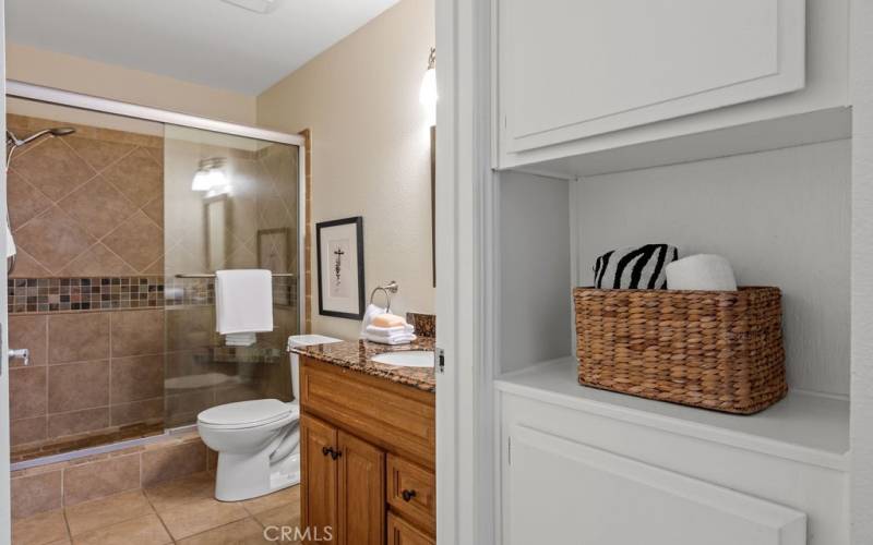 Linen cabinet adjacent to bathroom