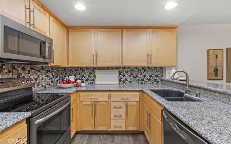 Upgraded kitchen with granite countertops and stainless appliances