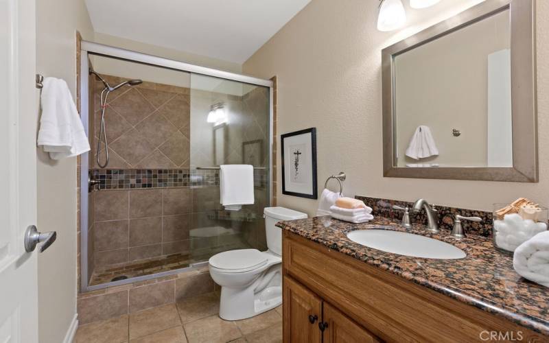 Upgraded bathroom with beautiful stone tile step-in shower