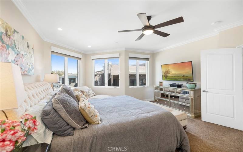 The primary bedroom with king bed and smart TV with walk in closet