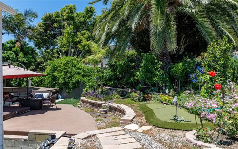 Shady patio area and private putting green in the lushly landscaped backyard!