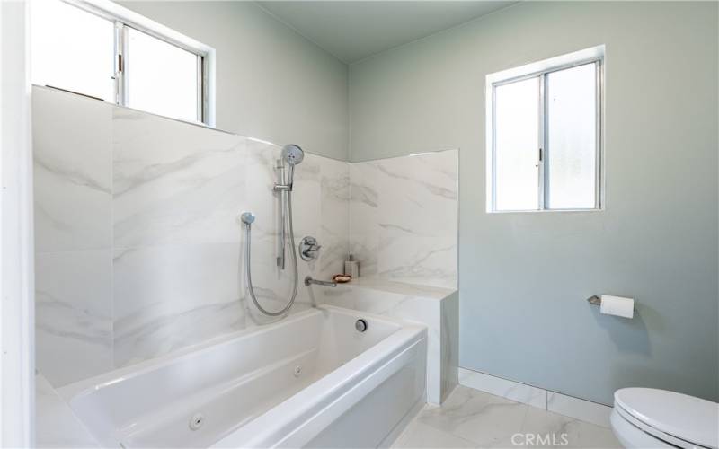 The primary suite bathroom has a jetted tub with high-end fixtures for a spa-like retreat in the privacy of your home!