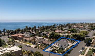 Live the California coastal dream just one block up from the Pacific Ocean on a spacious, gated corner lot!