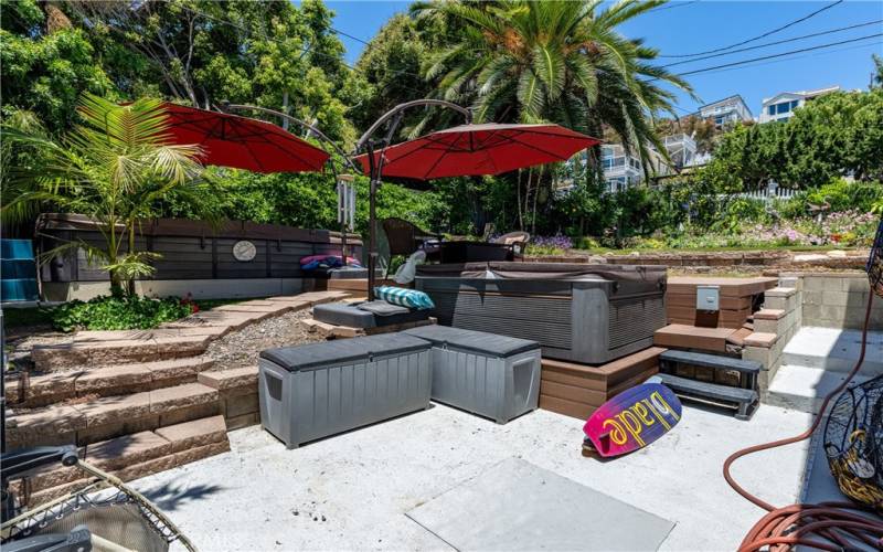 Lush, mature landscaping, an above-ground lap pool and jetted spa make this backyard your own private paradise!